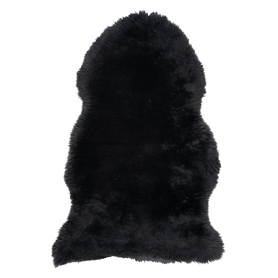 Molly the Sheepskin Mat in black Merino wool against a white backdrop